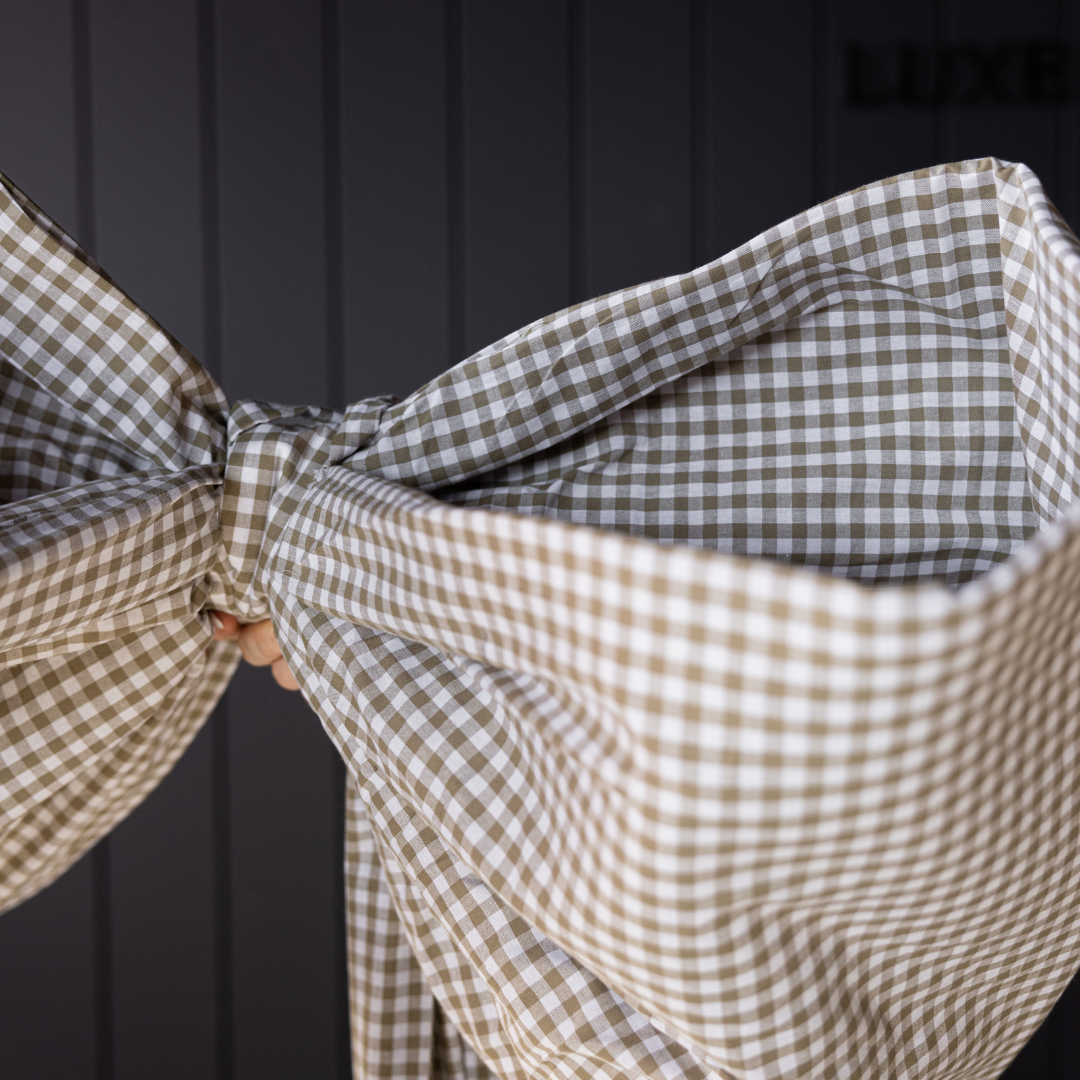 Large green gingham fabric bow by Luxe B Co, oversized accessory with a classic pattern, perfect for stylish hair or gift decoration.