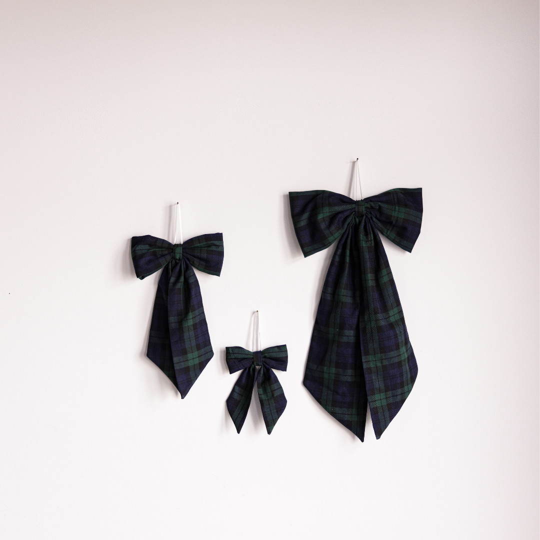 Green plaid fabric bows by Luxe B Co, featuring soft material and classic plaid pattern for stylish accessory or decoration.