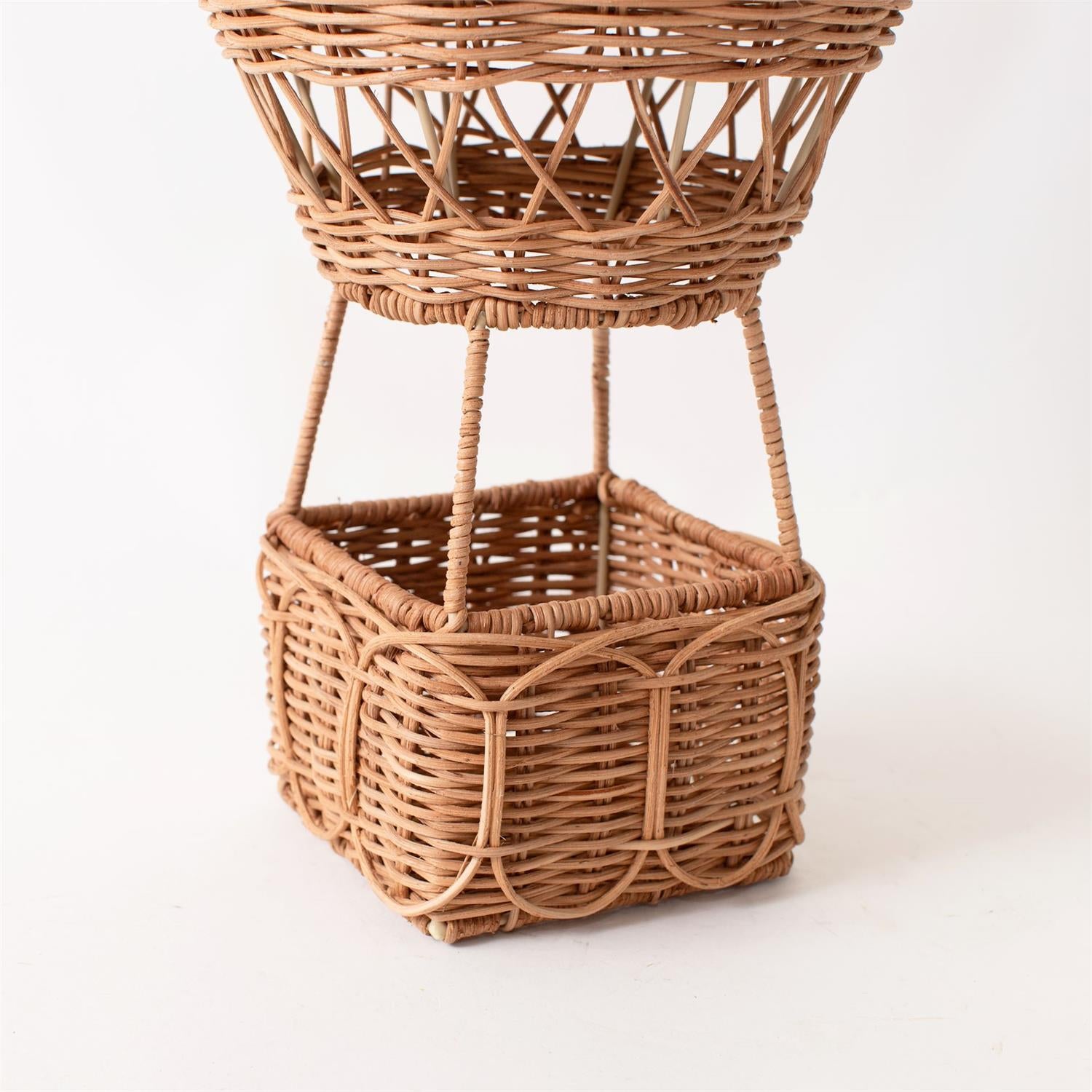 Decorative rattan hot air balloon ornament by Luxe B Co., featuring intricate weaving and natural rattan material.