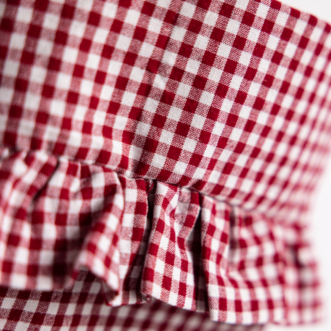 Red gingham holiday stocking by Luxe B Co featuring festive Christmas pattern and plush cuff.