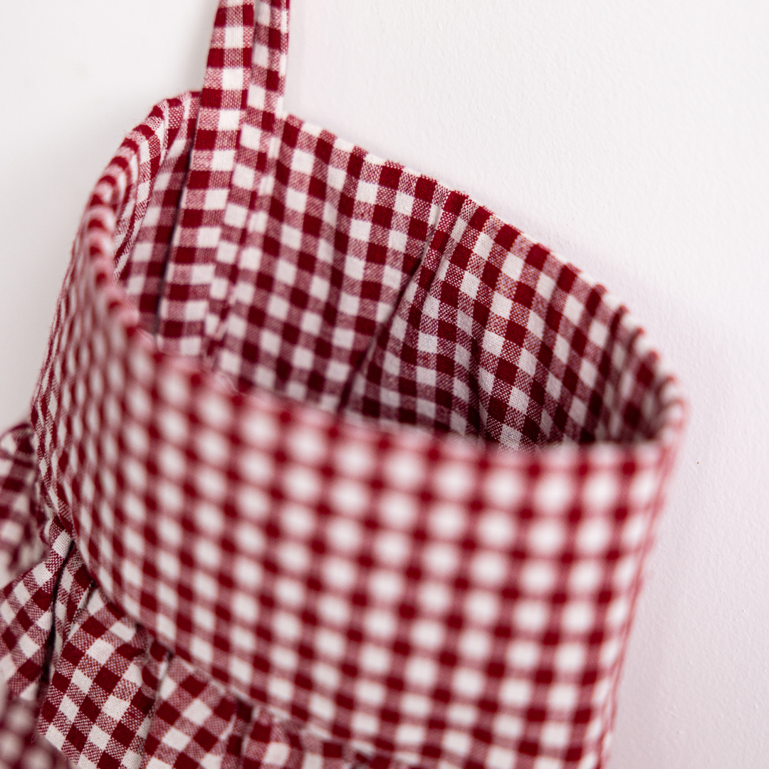 Red gingham holiday stocking by Luxe B Co with festive pattern, perfect for Christmas decor and seasonal gift hanging.
