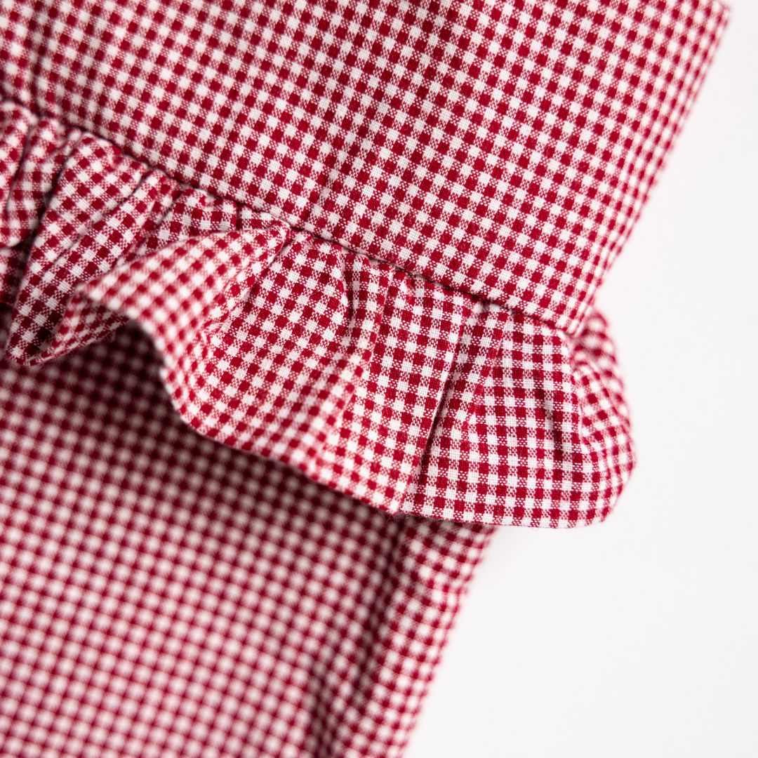 Red mini gingham holiday stocking by Luxe B Co featuring festive red and white checkered pattern with a plush cuff.