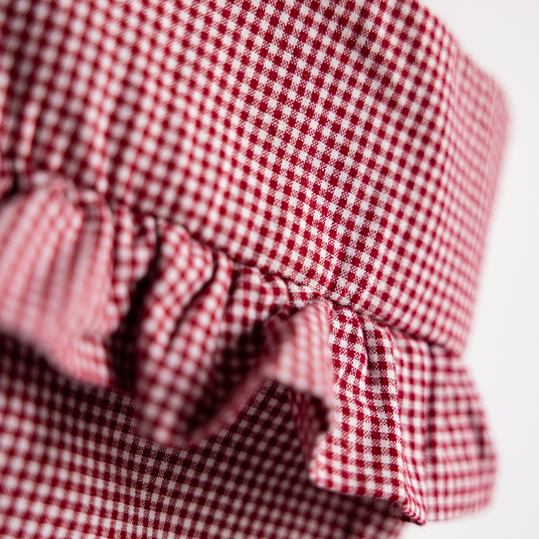 Red mini gingham holiday stocking by Luxe B Co featuring festive red and white checkered pattern and plush top detail.