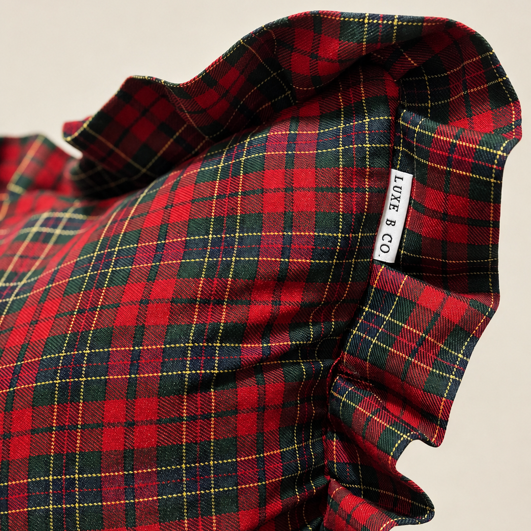Red plaid ruffle bolster pillow cover by Luxe B Co featuring soft fabric and decorative ruffle details.