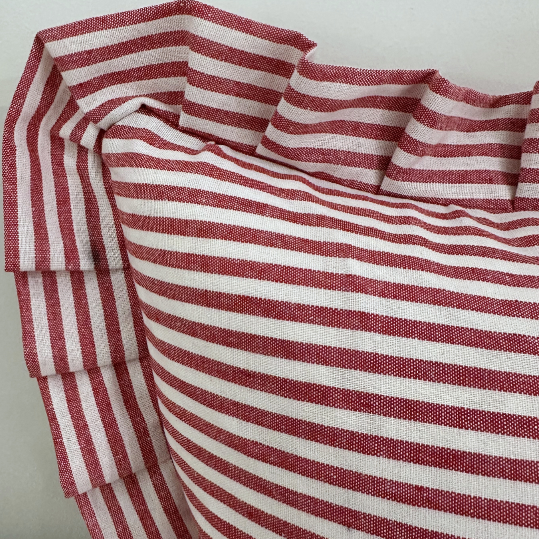 Red striped lumbar pillow sham with ruffle detail by Luxe B Co, showcasing soft fabric and decorative design for cozy decor.