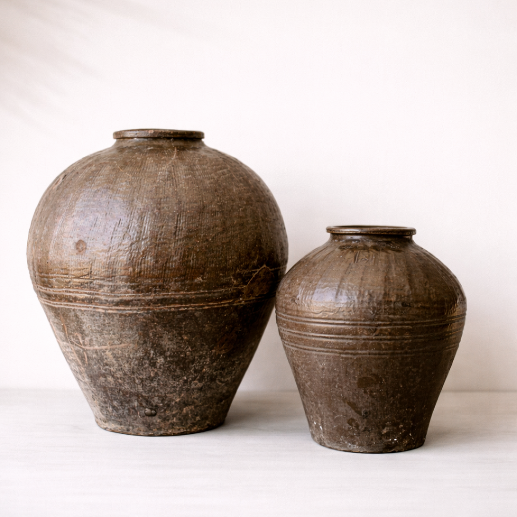 Two brown ceramic jars on a white background