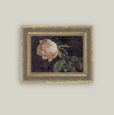 Framed antique-inspired art featuring a vase with a rose, created by Luxe B Co, displayed on a wall.