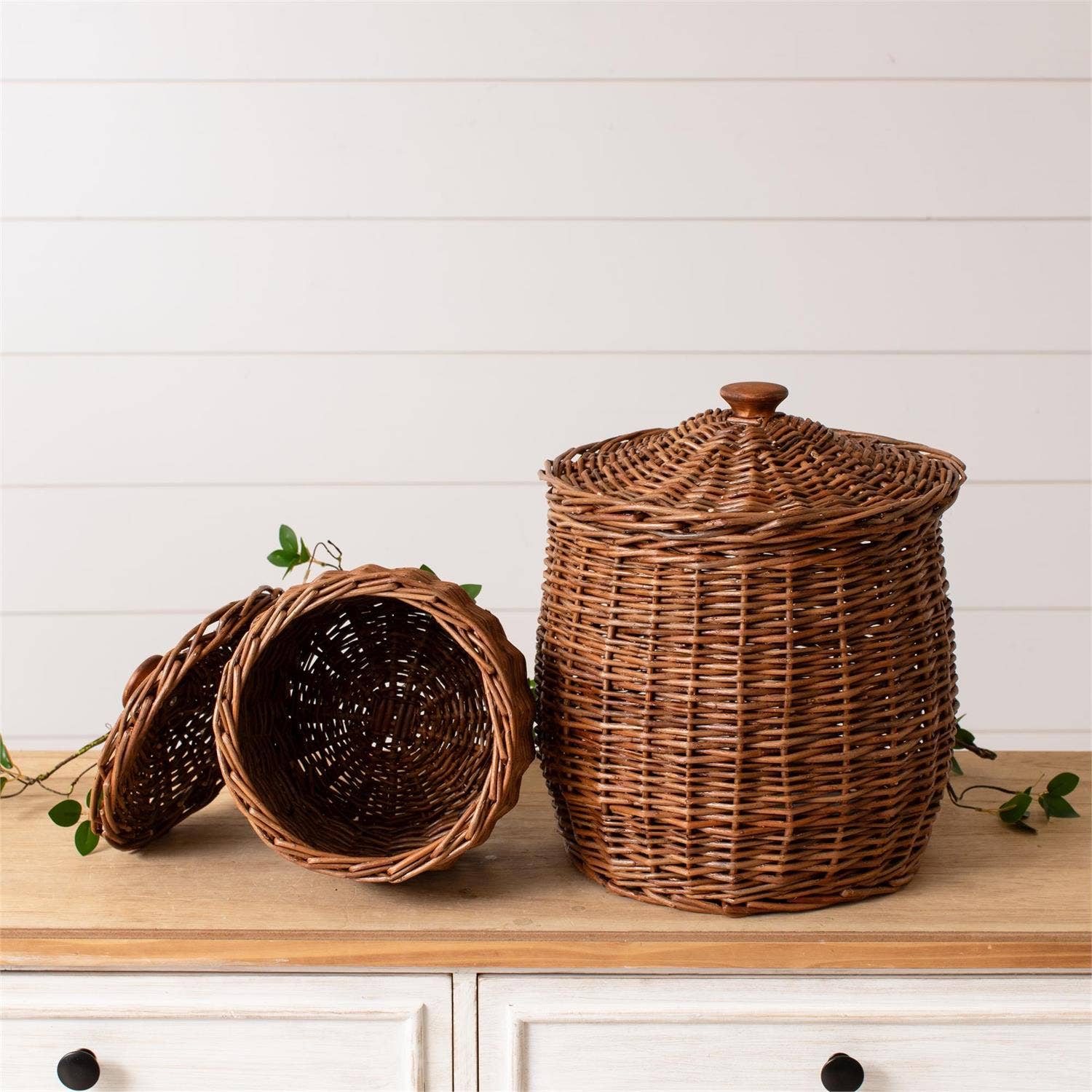 Set of two wicker storage baskets with lids by Luxe B Co., featuring natural woven design for stylish organization.
