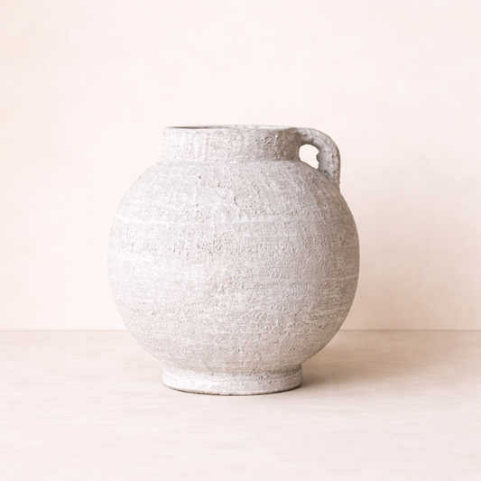 Textured ceramic vase on a plain background