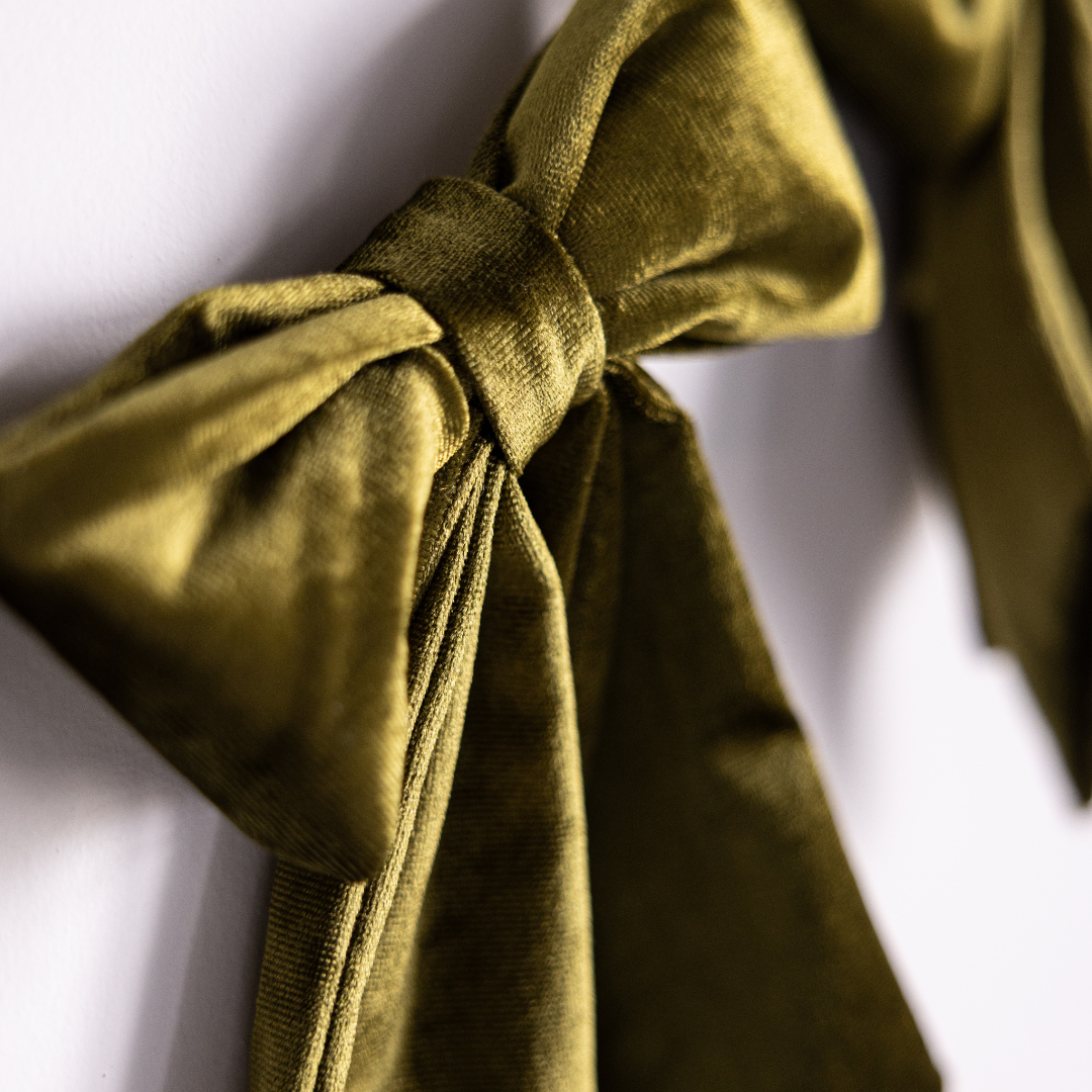 Mini chartreuse velvet fabric bow garland featuring Luxe B Co brand bows, perfect for holiday or festive decor.