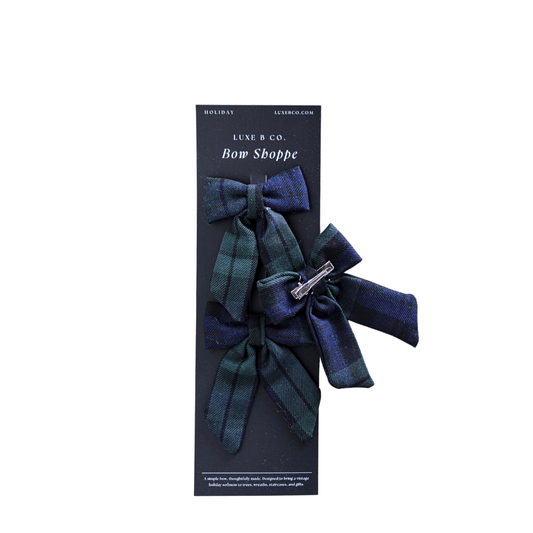 Set of green plaid mini fabric bows with clips from Luxe B Co, perfect for holiday or decorative use.
