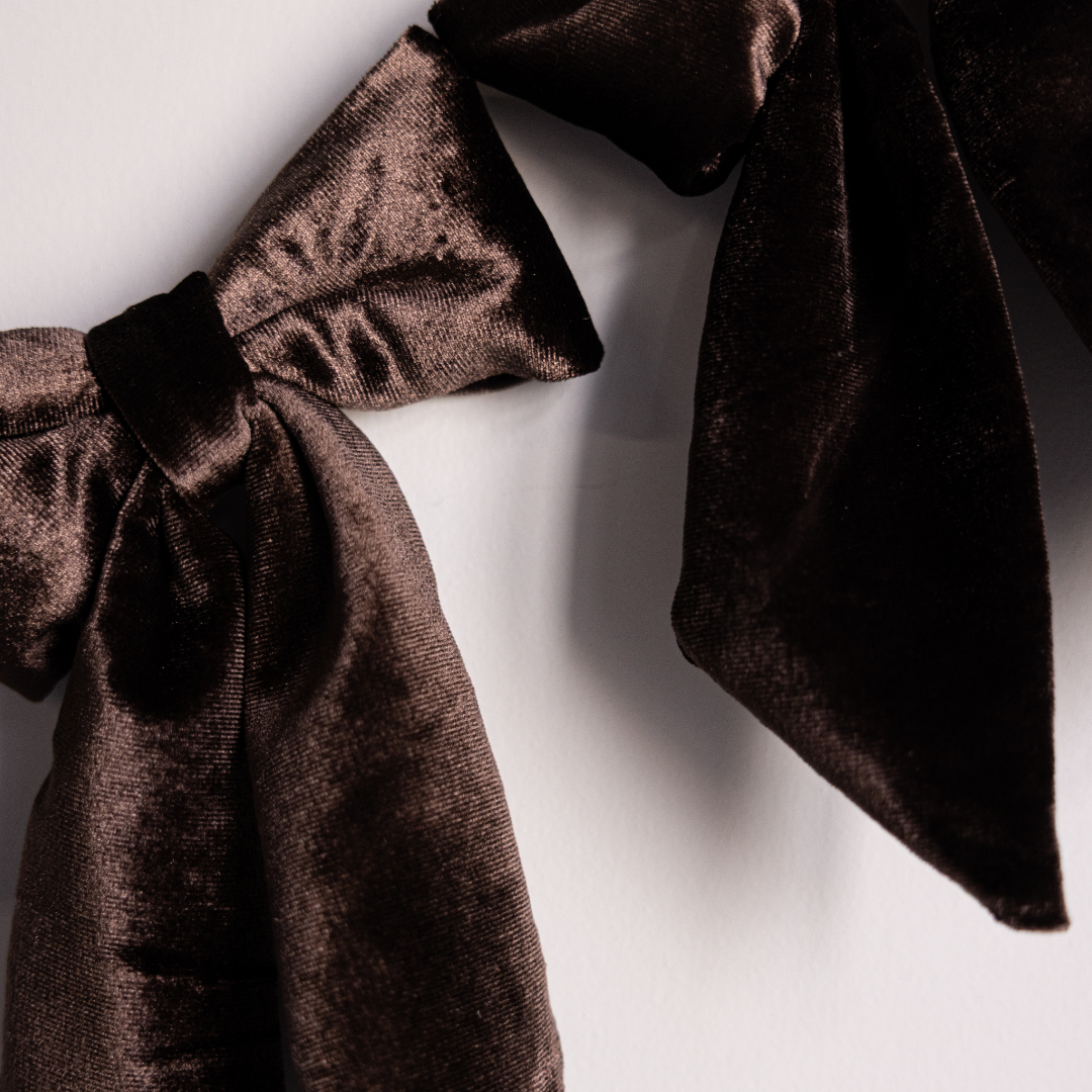 Brown velvet fabric bow garland featuring elegant Luxe B Co bows, perfect for holiday decorations and festive decor.